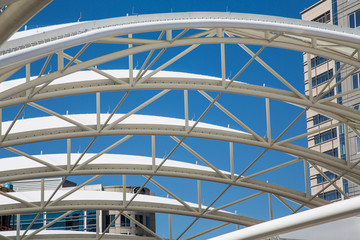 White Curved Tubular Steel Architecture Under Blue Sky