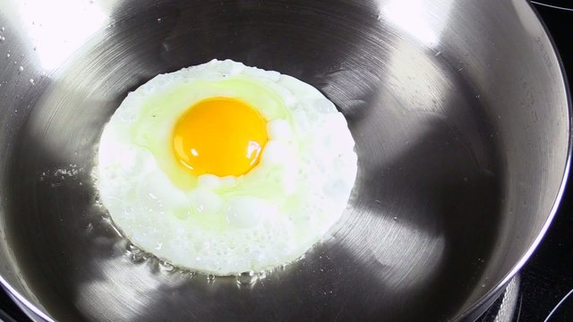 Fried eggs on a steel pan
