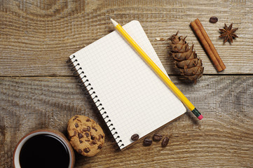 Notepad and coffee with cookies