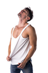 Fototapeta premium Young athletic man pulling down tanktop