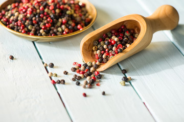 Wooden spoon with colorful chili seeds