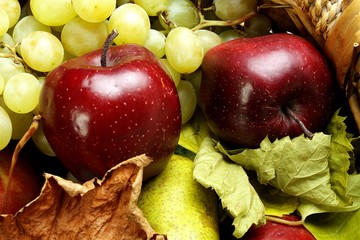 Naklejka na ściany i meble Red apples on the background of other fruit