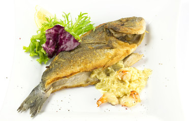 Fried fish dorado with vegetables and lemon