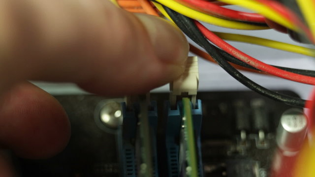 Installing RAM memory modules into PC motherboard.