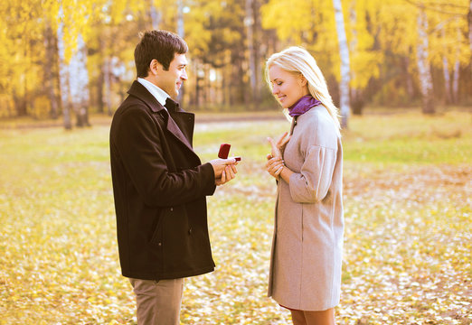 Love, couple, relationship and engagement concept - man proposin