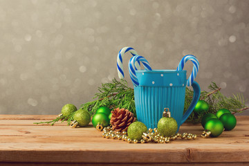 Christmas decorations with blue cup and candy on wooden table