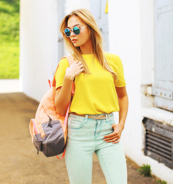 Summer street fashion, stylish hipster girl in sunglasses posing