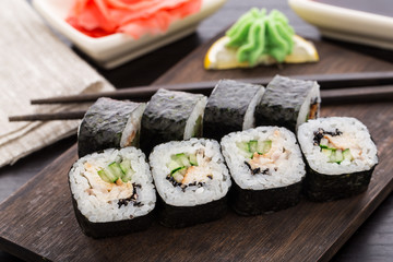 Sushi rolls with eel, cucumber and sesame seed