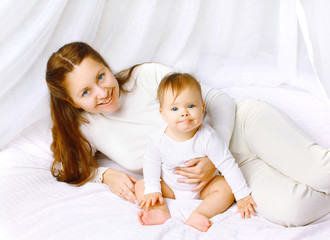 Portrait lovely happy mother and baby in bed home