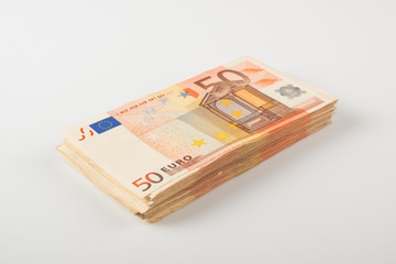 Pile of fifty euro banknotes