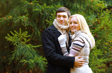 Christmas and people concept - happy pretty couple against chris