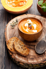 Pumpkin soup on wooden board