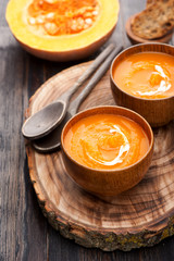 Pumpkin soup on wooden board