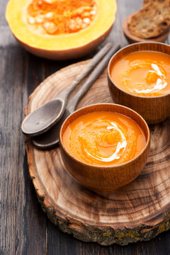 Pumpkin soup on wooden board