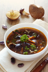 Bowl of soup with kidney beans and  mushrooms