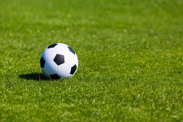 Green pitch with soccer ball