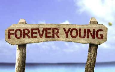 Forever Young sign with a beach on background