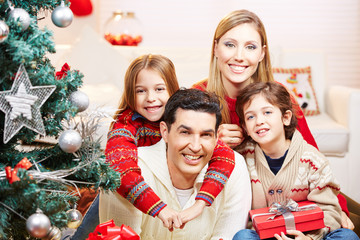 Obraz na płótnie Canvas Glückliche Familie mit zwei Kindern an Weihnachten