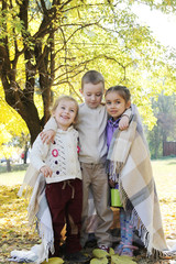 Sisters and brother hugging in plaid