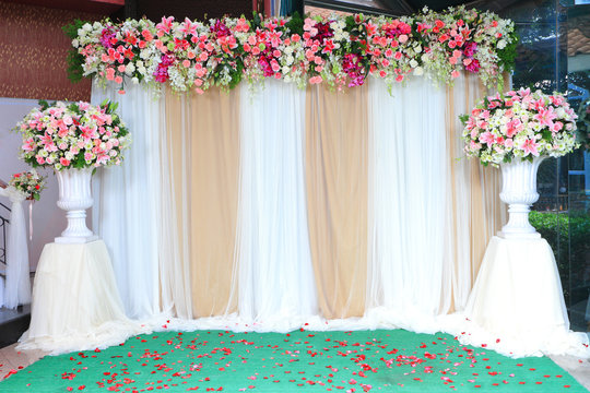 Colorful backdrop flowers with white and gold fabric arrangement