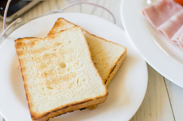 Breakfast with toasts and pork sliced ham