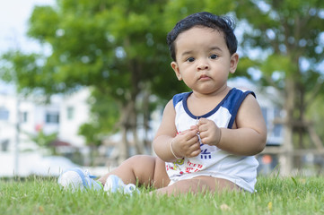 Chubby boy in grass