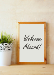 drawing board with the phrase welcome aboard handwritten over wo