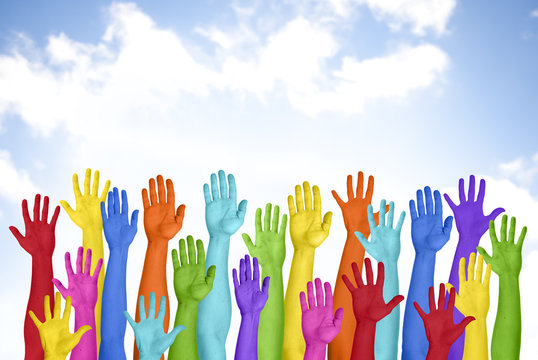 Colorful Hands Raised With Blue Sky