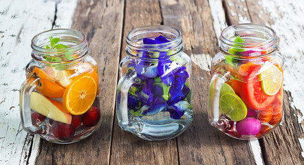 Three mug delicious refreshing drink of mix fruits and herb on w