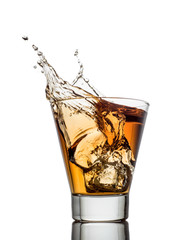 Isolated shots of whiskey with splash on white