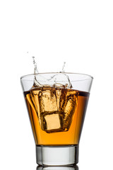 Isolated shots of whiskey with splash on white