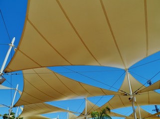 A roof of sunscreens shaped like sails in the desert of Austr