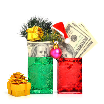 Handred dollars gift in pacage with christmas hat, bauble and pi