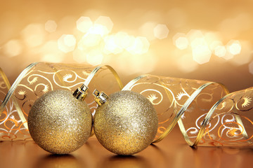 Christmas or holiday background with golden ornaments and ribbon