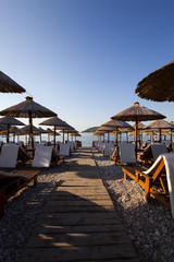   the photographed wooden umbrellas located in the territory of a beach