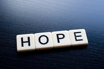 Obraz premium Hope on dark wood background