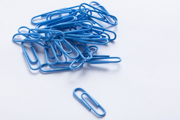 a collection of paperclips on a white surface