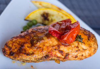 chicken fillet baked in spices and tomatoes, vegetables
