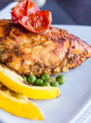 whole chicken fillet baked in a spicy sauce with vegetables