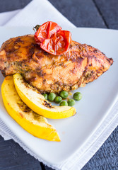 whole chicken fillet baked in a spicy sauce with vegetables