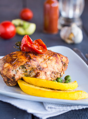 whole chicken fillet baked in a spicy sauce with vegetables