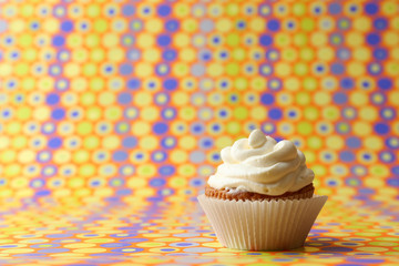 Delicious birthday cupcake on bright background