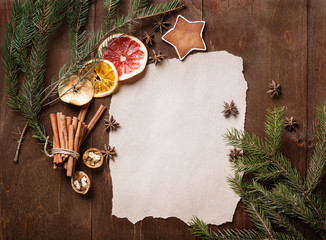 Christmas cookies and spruce branches on  wooden background.