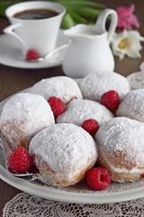 Berliner with jam filling, powdered sugar and raspberry garnish