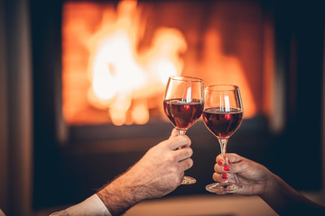 glasses red wine and fireplace