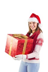 Young woman in stylish warm clothing holding a gift