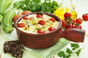 Zucchini baked with chicken, cherry tomatoes and herbs