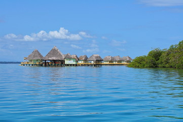 Fototapeta na wymiar Eco resort over water with thatched cabins Panama