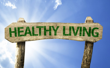 Healthy Living wooden sign on a beautiful day