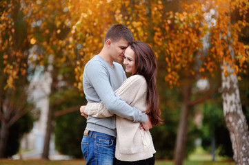 Fototapeta premium Man and woman embracing in autumn park